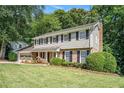 Well-maintained two-story home boasting a spacious front yard and a classic architectural design at 1703 W Nancy Creek Ne Dr, Brookhaven, GA 30319