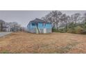 View of the back of the home with backyard and street in the background at 1730 Spring Ne St, Conyers, GA 30012