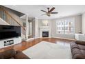 Spacious living room showcasing hardwood floors, a fireplace and a ceiling fan at 3542 Chattahoochee Summit Se Ln, Atlanta, GA 30339