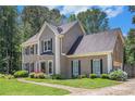 Beautiful home with a manicured lawn, colorful flowerbeds, and a welcoming walkway at 3774 Seasons Nw Dr, Acworth, GA 30101