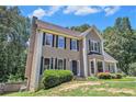 View of a charming home with a manicured lawn and lush landscaping at 3774 Seasons Nw Dr, Acworth, GA 30101