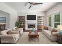 Bright living room featuring a fireplace, ceiling fan, and lots of natural light at 3774 Seasons Nw Dr, Acworth, GA 30101