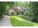 Beautiful home with lush landscaping, mature trees, and a long driveway at 4219 Harrogate Nw Dr, Atlanta, GA 30327