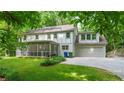 The back of the home features a screened-in porch, two-car garage and lovely yard at 4219 Harrogate Nw Dr, Atlanta, GA 30327