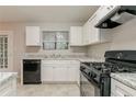 Bright kitchen featuring plenty of counter space, a gas range, and stainless steel sink at 4905 Sandberg Ct, Stone Mountain, GA 30088