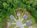 Aerial view showcases property lines of home nestled amongst lush greenery at 6160 Overleaf Ter, Cumming, GA 30040