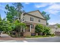 Charming two-story home with brick and siding exterior, lush landscaping, and welcoming front entrance at 148 Canton St, Alpharetta, GA 30009