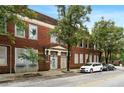 Exterior daytime view of a two-story brick building with street access and parked cars at 210 Walker Sw St # 3, Atlanta, GA 30313