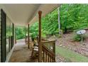 Inviting covered porch, perfect for relaxing and enjoying the peaceful wooded surroundings at 345 Jesse Martin Trl, Canton, GA 30115
