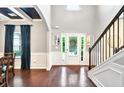 Spacious foyer with hardwood floors, wainscoting, and a staircase leading to the upper level at 3975 Silverthorn Trce, Cumming, GA 30028