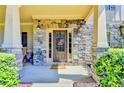Charming front porch with stone columns and facade, offering a warm welcome to visitors at 3975 Silverthorn Trce, Cumming, GA 30028