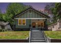 Charming craftsman-style home featuring a large front porch, green siding, and a well-maintained front yard at 905 Gaston Sw St, Atlanta, GA 30310