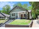 Charming craftsman-style home featuring a large front porch, green siding, and a well-maintained front yard at 905 Gaston Sw St, Atlanta, GA 30310