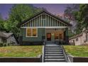 Lovely home with a covered front porch and manicured front lawn, creating a warm welcome at 905 Gaston Sw St, Atlanta, GA 30310