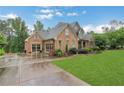 Beautiful home featuring brick exterior, three-car garage, and a well-manicured lawn at 26 Trillium Ln, Acworth, GA 30101