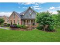 Inviting two-story home with a brick facade, manicured landscaping, and lush green lawn at 26 Trillium Ln, Acworth, GA 30101