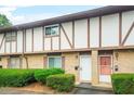 Traditional townhome featuring a brick facade and well-maintained landscaping with trimmed hedges at 2952 N Dekalb Dr # C, Atlanta, GA 30340