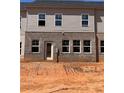 Back of the townhome with the door, brick exterior, and level area for backyard fun at 3106 Marbella Cir # 3, Kennesaw, GA 30152
