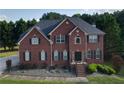 Classic two-story brick home with tidy landscaping and a welcoming front entrance at 3898 Heritage Oaks Dr, Powder Springs, GA 30127