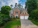 Classic brick residence with a well-maintained lawn and driveway, offering a welcoming curb appeal at 540 Shale Ct, Alpharetta, GA 30022