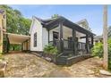 A charming home featuring a covered carport, a covered porch, and landscaping at 1192 Arlington Sw Ave, Atlanta, GA 30310
