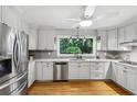 Modern kitchen with stainless steel appliances, granite countertops, and a large window overlooking the backyard at 2516 Cherry Hill Ln, Atlanta, GA 30360