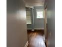 Hallway featuring hardwood floors, neutral paint, and access to other rooms, offering a clean transition at 2855 Peachtree Ne Rd # 106, Atlanta, GA 30305