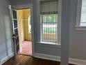 Inviting living room with hardwood floors, natural light, and an open doorway to a covered porch at 2855 Peachtree Ne Rd # 106, Atlanta, GA 30305