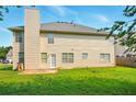 View of the home's rear exterior, including a spacious yard and patio area at 3731 Laramie Rd, Ellenwood, GA 30294