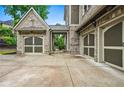 Spacious three-car garage with brick facade and carriage-style doors, providing ample parking and storage at 771 Tate Overlook, Marietta, GA 30064