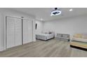 Bright bedroom with modern flooring, a fan, and a closet at 1701 English Ivey Nw Ln, Kennesaw, GA 30144