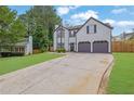 Well-maintained two-story home with a spacious driveway and lush green lawn at 1701 English Ivey Nw Ln, Kennesaw, GA 30144