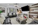 Cozy living room with a fireplace, a large TV, and comfortable seating at 1701 English Ivey Nw Ln, Kennesaw, GA 30144