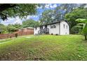 Landscaped front yard with a freshly painted exterior and welcoming entrance at 569 Oakside Sw Dr, Atlanta, GA 30331