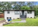 Inviting one-story house boasts a freshly painted exterior and manicured lawn at 569 Oakside Sw Dr, Atlanta, GA 30331