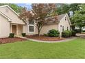 Charming home featuring a well-maintained lawn and attractive landscaping at 775 Tribble Cove Dr, Lawrenceville, GA 30045