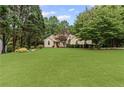 Beautiful home with a large front lawn and plenty of trees providing shade at 775 Tribble Cove Dr, Lawrenceville, GA 30045