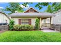 Charming single story home with a well manicured lawn, quaint front porch, and picket fence at 176 Ormond Se St, Atlanta, GA 30315