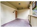 Covered front porch with a wood floor, stained glass window, and view of the yard at 176 Ormond Se St, Atlanta, GA 30315