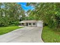 Beautiful exterior view of home, including a long driveway and manicured lawn at 2326 Brackett Sw St, Marietta, GA 30060