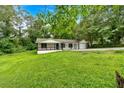 Exterior of lovely home featuring an expansive green yard and mature trees at 2326 Brackett Sw St, Marietta, GA 30060