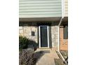 Close up of a townhome front door with stone accents and a small porch at 4701 Flat Shoals Rd # 48B, Union City, GA 30291