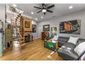 Open living room with hardwood floors, exposed brick, spiral staircase, and ample natural light at 611 Pickett Se St, Atlanta, GA 30316