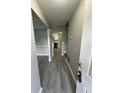 Welcoming hallway with modern gray laminate flooring that leads into the main living spaces at 5388 Robertson Path, Lithonia, GA 30038