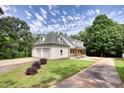 The exterior of a well-maintained home with an attached garage and lush green lawn at 80 Surrey Chase Drive, Social Circle, GA 30025