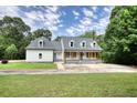 Beautiful home featuring a manicured lawn and traditional architectural style at 80 Surrey Chase Drive, Social Circle, GA 30025