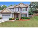 Beautiful home with green lawn, flower beds, and an attached garage; ideal for suburban living at 1099 Sandy Bank Ct, Auburn, GA 30011