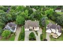 Expansive aerial view of a home surrounded by lush greenery in a quiet neighborhood at 2503 Regency Lake Dr, Marietta, GA 30062