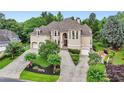 Elegant two-story residence with a three-car garage, lush landscaping, and a welcoming front entrance at 2503 Regency Lake Dr, Marietta, GA 30062