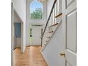 Light-filled foyer with hardwood floors and staircase, leading to a large window at 3915 Woolbridge Way, Marietta, GA 30062